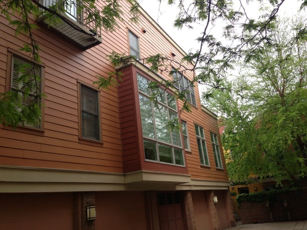 A building with many windows and trees in the background.