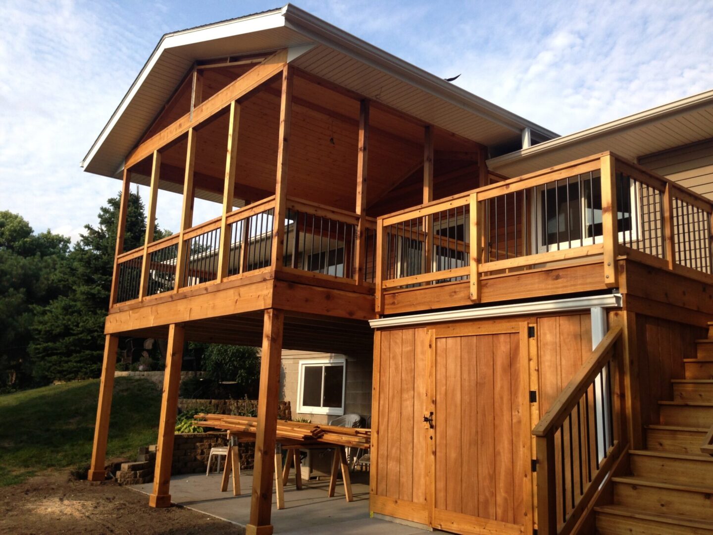 A wooden deck with a table and chairs outside.